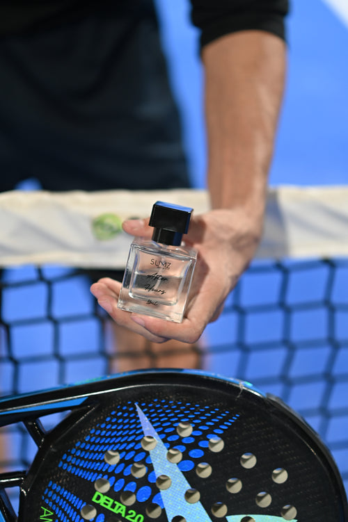 SUMZ After Hours unisex hair perfume bottle beside a racket